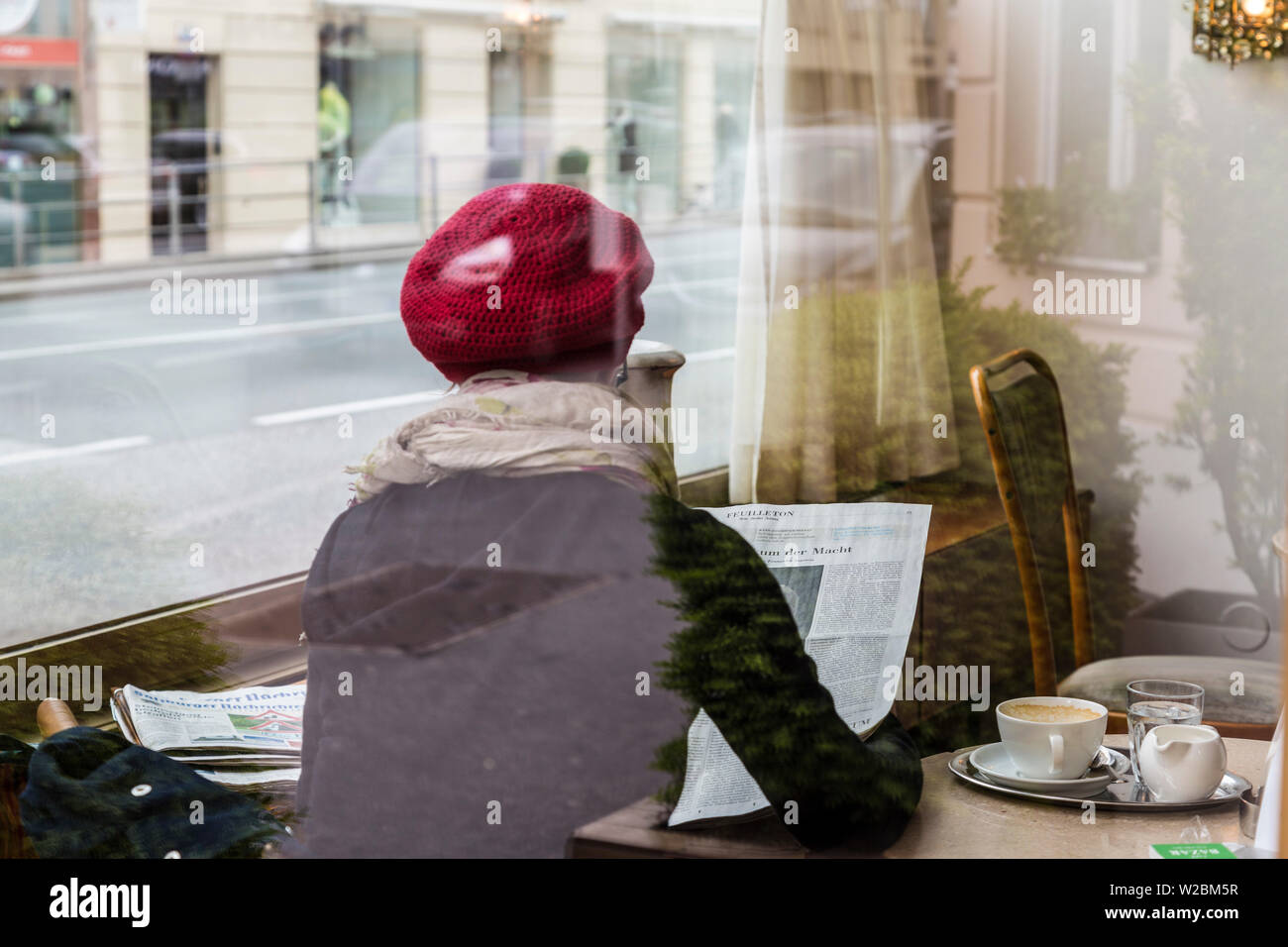 Woman sat in cafe, Salzburg, Austria Stock Photo