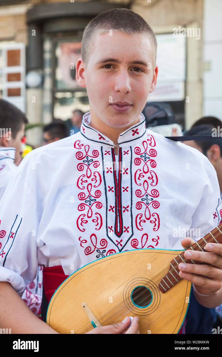 Bulgaria, Central Mountains, Kazanlak, Kazanlak Rose Festival, town produces 60% of the world's rose oil, young man in traditional costume with mandolin, NR Stock Photo