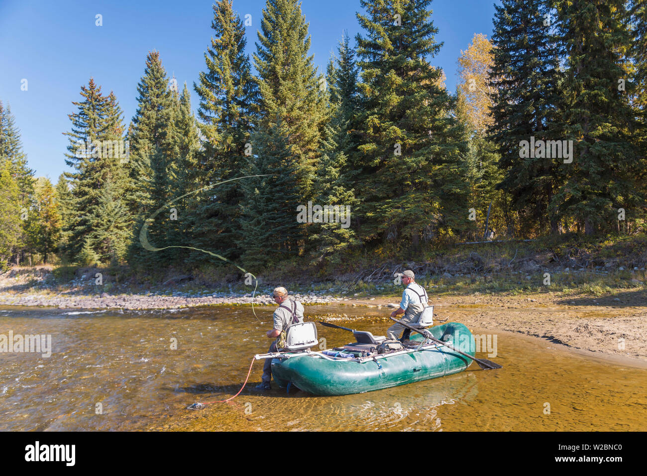 Fly fishermen casting & fishing from boat, British Columbia, Canada Stock Photo