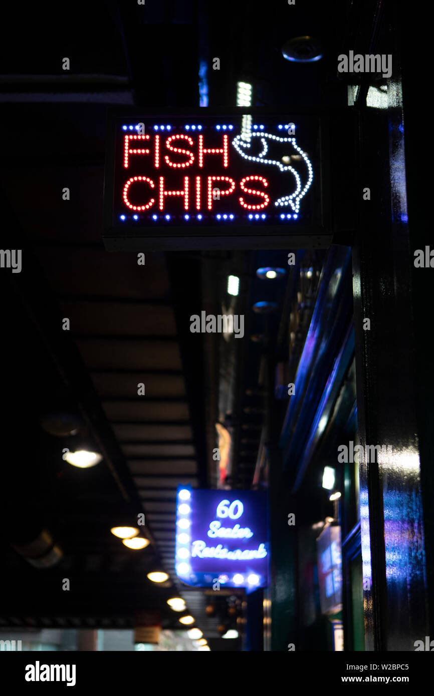 neon advertising sign for fish and chips in Glasgow Stock Photo