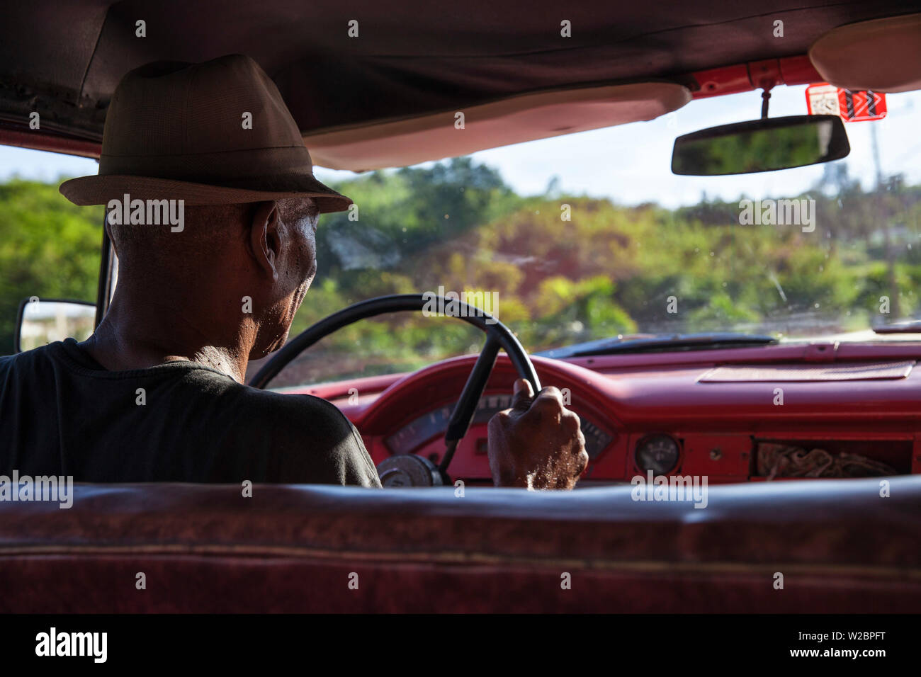 Cuba, Santiago de Cuba Province, Santiago de Cuba, Man driving Classic American car Stock Photo