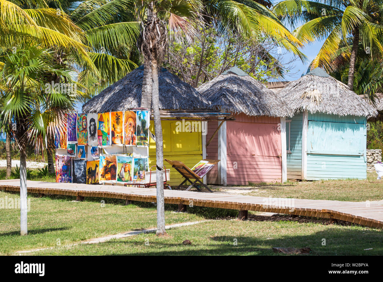 Cuba, Jardines del Rey, Cayo Guillermo, Playa El Paso, Paintings for sale outside thatched hut at Melia Hotel Stock Photo