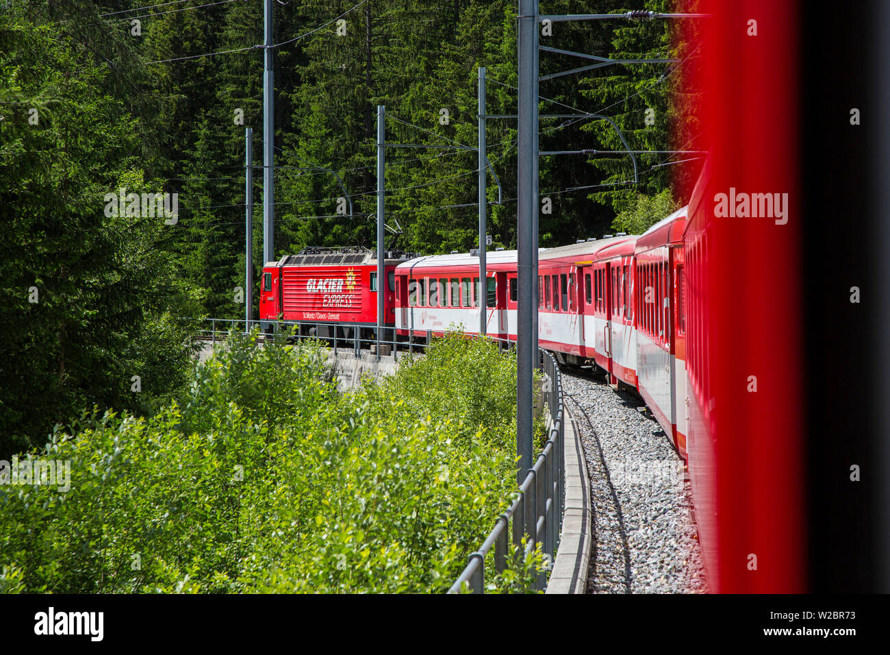 Glacier Express train climbing towards Zermatt, Valais, Switzerland Stock Photo