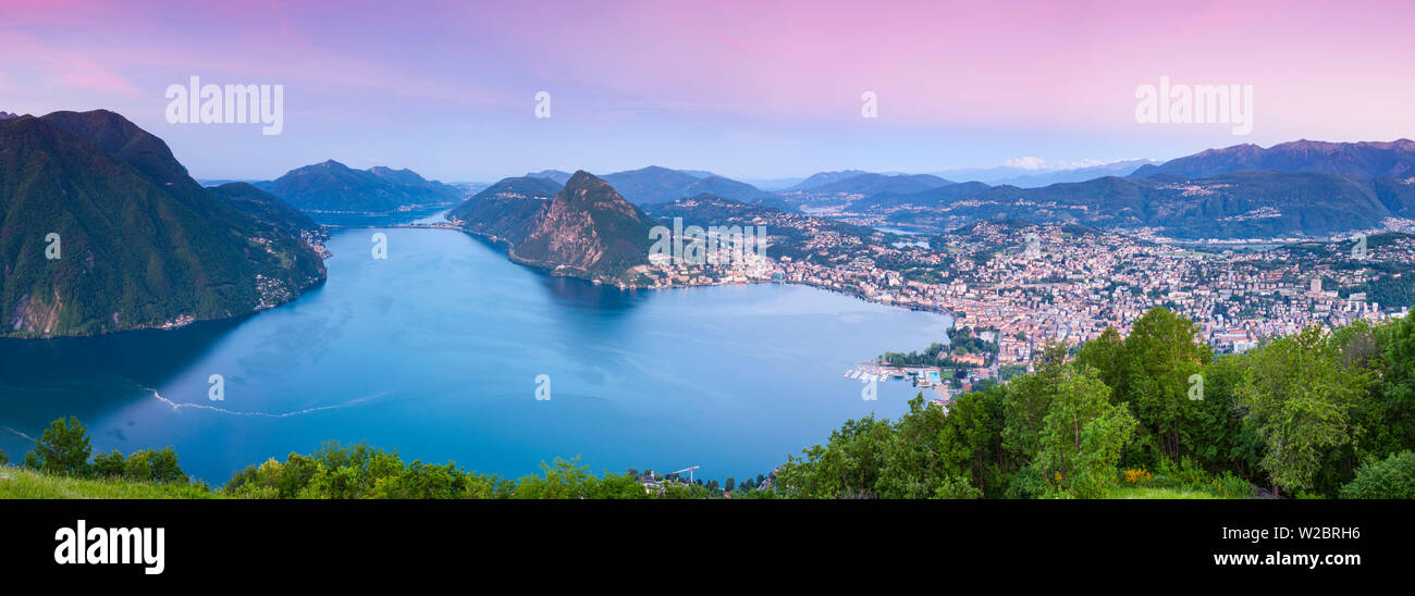 Elevated view over Lugano from Monte Bre illuminated at sunrise, Lugano, Lake Lugano, Ticino, Switzerland Stock Photo
