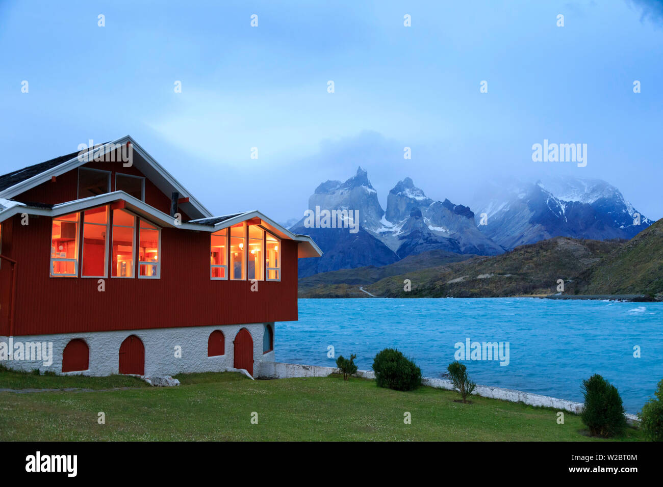 Chile, Patagonia, Torres del Paine National Park (UNESCO Site), Cuernos del Paine peaks and Hosteria Peohe Historic Hotel Stock Photo