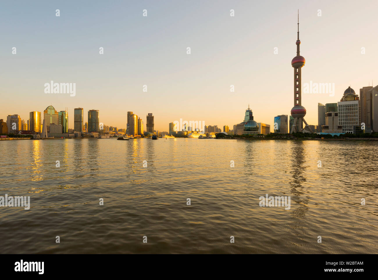 China, Shanghai, Pudong District, Skyline of the Financial District across Huangpu River at sunrise Stock Photo