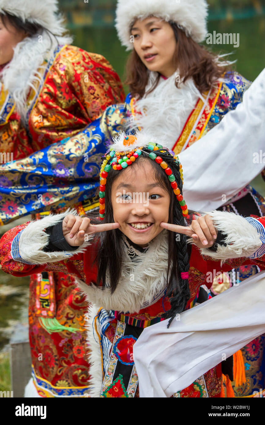 Girl in in traditional dress, Jiuzhaigou National Park, Sichuan Province, China Stock Photo