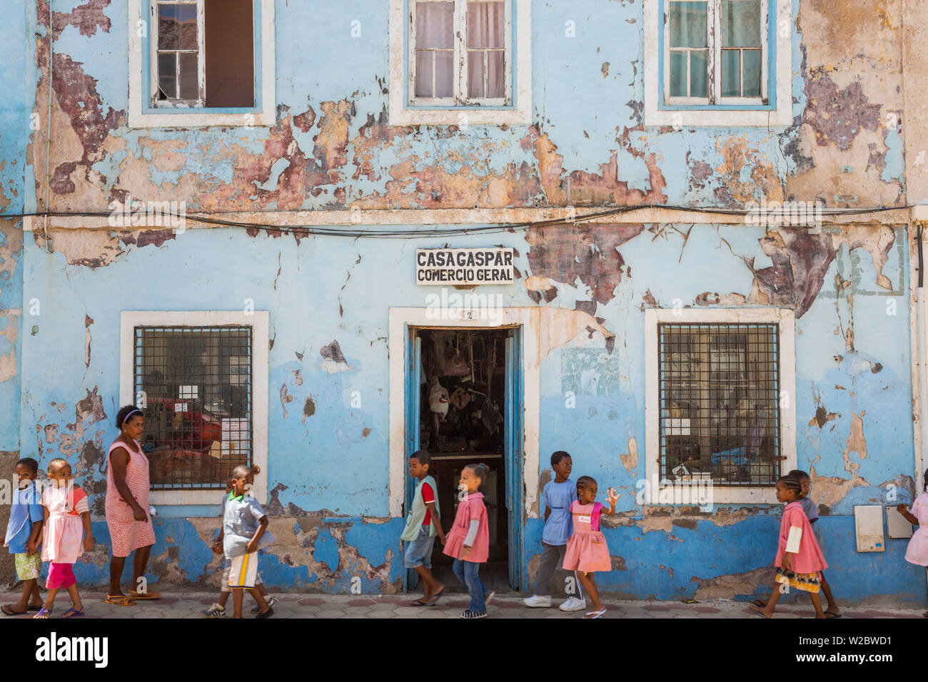 School children passing shop, Mindelo, Sao Vicente, Cape Verde Stock Photo