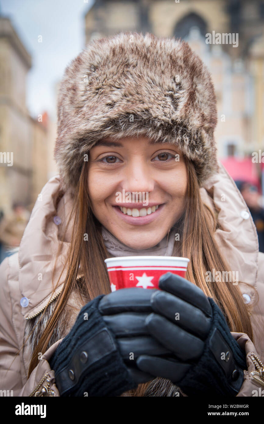 Young woman drinking gluhwein at the Christmas Market, Old Town Square, Prague, Czech Republic (MR) Stock Photo