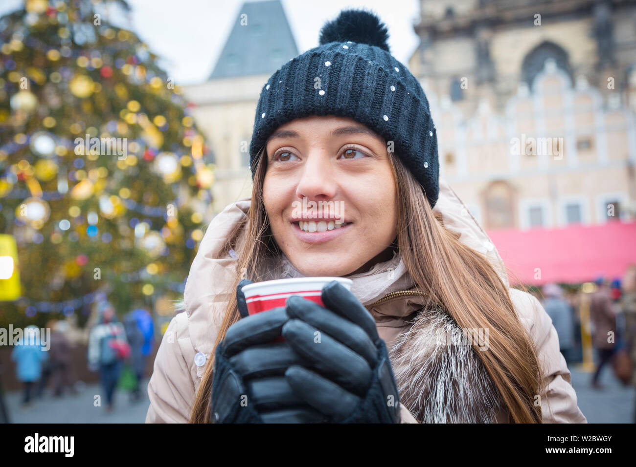 Young woman drinking gluhwein at the Christmas Market, Old Town Square, Prague, Czech Republic (MR) Stock Photo