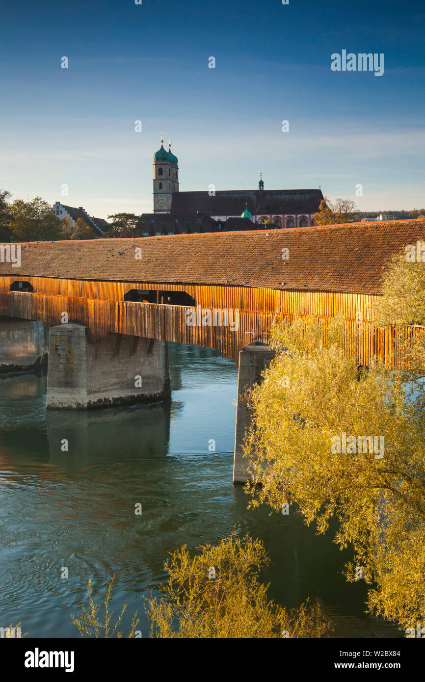 Germany, Baden-Wurttemburg, Black Forest, Bad Sackingen, the 400 year old wooden Rhein River bridge and Munster St. Fridolin, late afternoon Stock Photo
