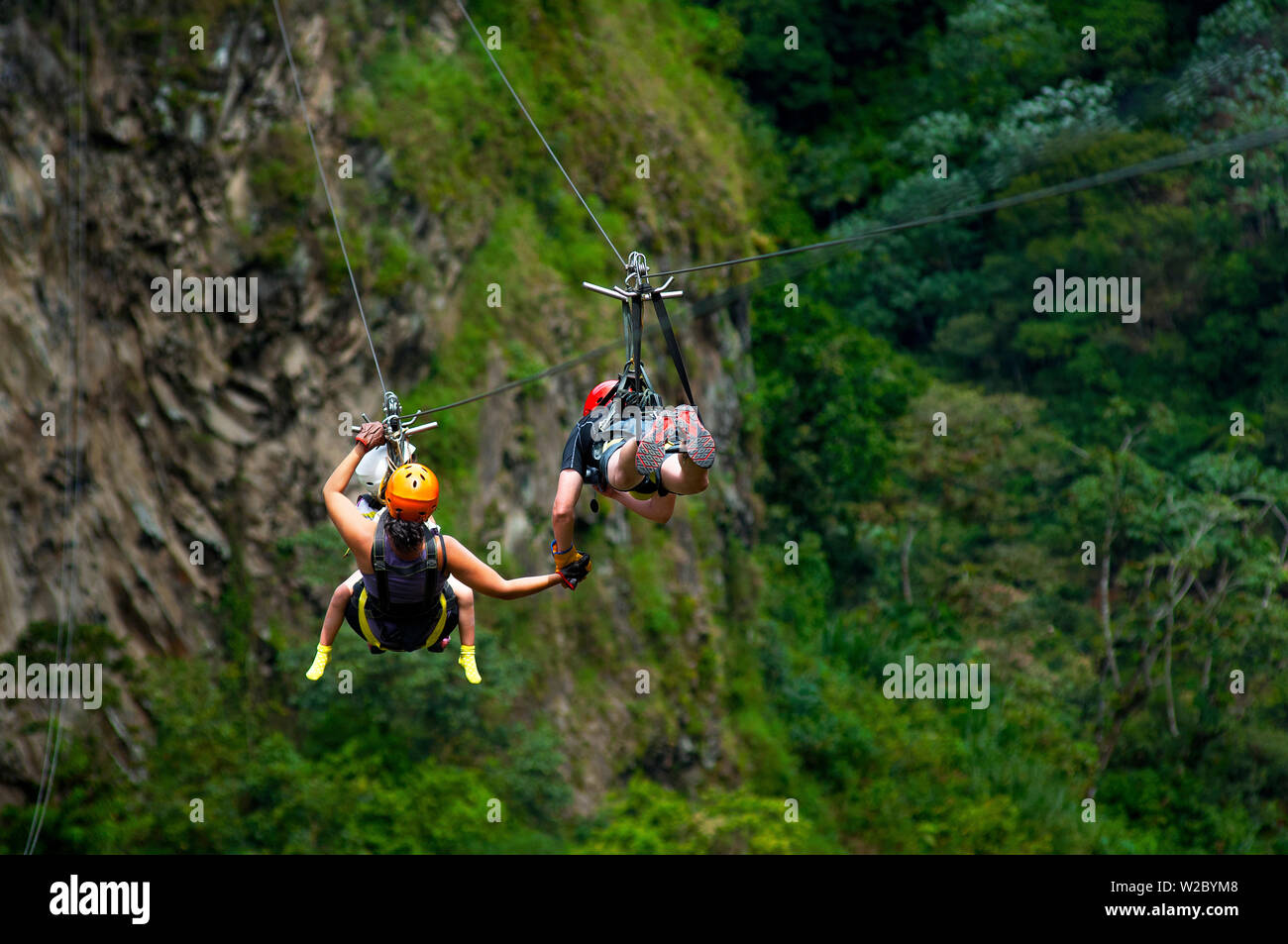 Family Zip Lining Over The Rio Pastaza Valley, River Gorge, Tourists, Route of The Waterfalls, Ruta de las Cascadas, Banos, Gateway To The Amazon, Tungurahua Province, Ecuador Stock Photo