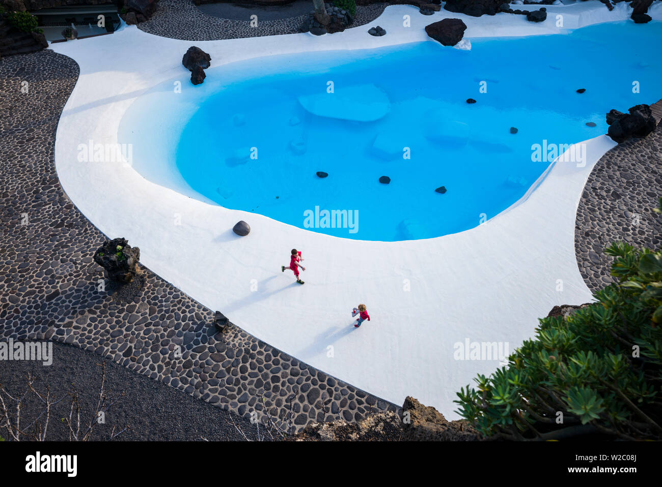 Spain, Canary Islands, Lanzarote, Jameos del Agua, complex inside old lava tube, designed by Cesar Manrique, exterior pool Stock Photo