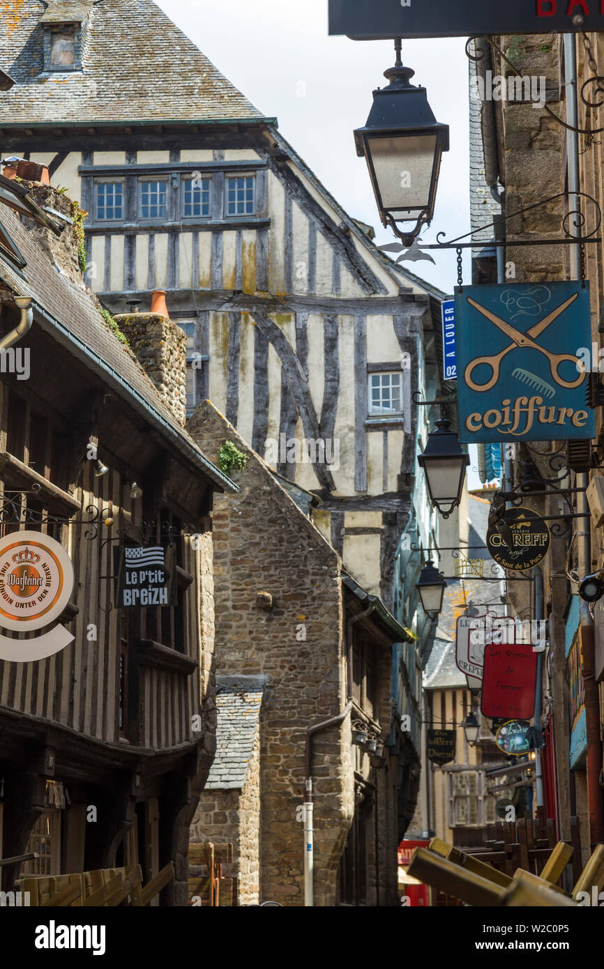 Medieval half-timbered houses and shop signs, Dinan, Brittany, France Stock Photo