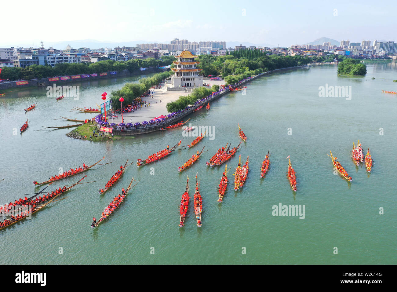 (190708) -- BEIJING, July 8, 2019 (Xinhua) -- Aerial photo taken on June 3, 2019 shows people participating in a dragon boat race held on the Xiaoshui River in Daoxian County, central China's Hunan Province. Located in central China, Hunan Province is well-known for its varied topography. It abuts the Dongting Lake to the north, and the east, south and west sides of the province are surrounded by mountains, with Wuling and Xuefeng Mountains to the west, Nanling Mountain to the south, Luoxiao and Mufu Mountains to the east. The Xiangjiang, Zijiang, Yuanjiang and Lishui Rivers converge on the Ya Stock Photo