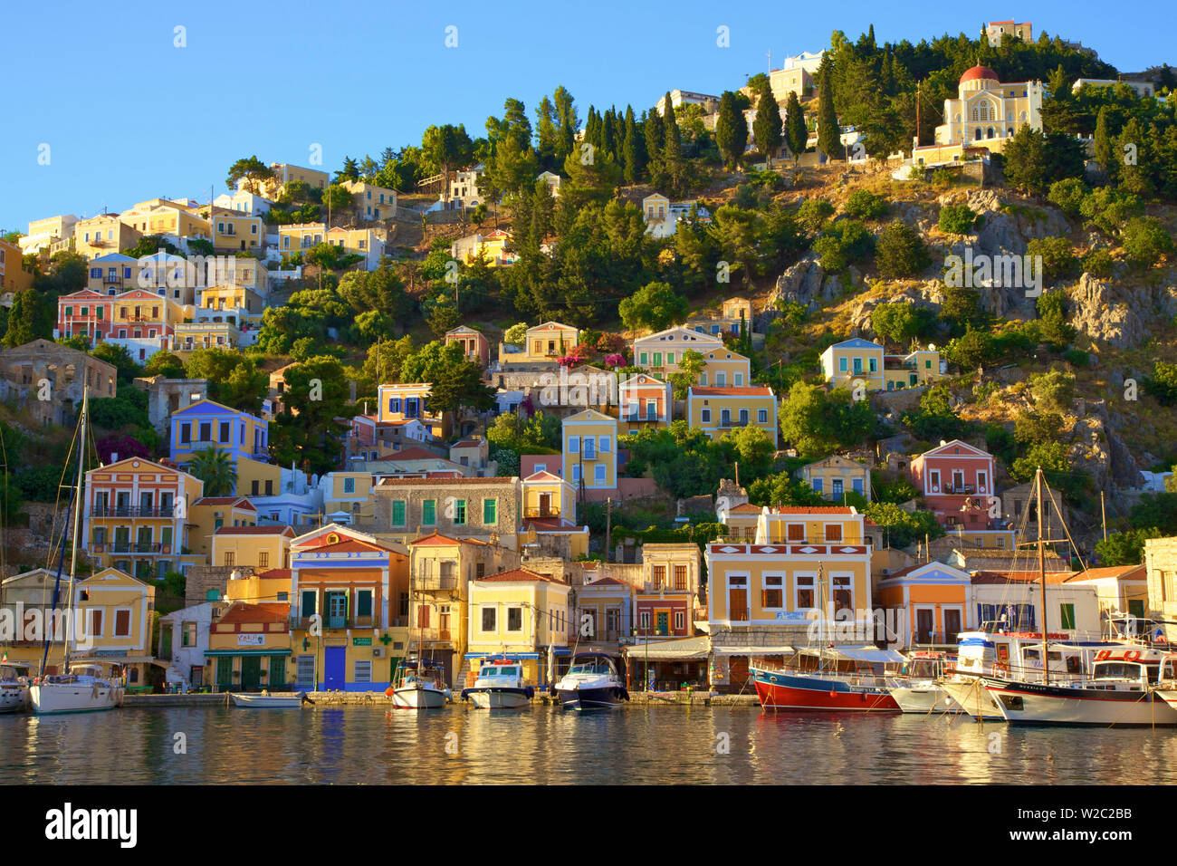 Boats In Symi Harbour, Symi, Dodecanese, Greek Islands, Greece, Europe Stock Photo