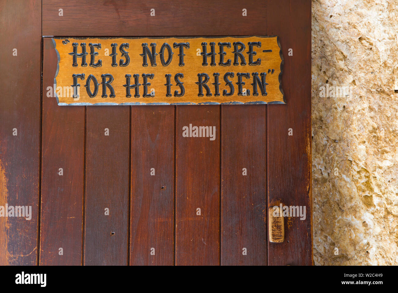Israel, Jerusalem, The Garden Tomb, a possible site of the burial and resurrection of Jesus, Wooden door bearing the  words, 'He is not here - for he is risen.' Stock Photo