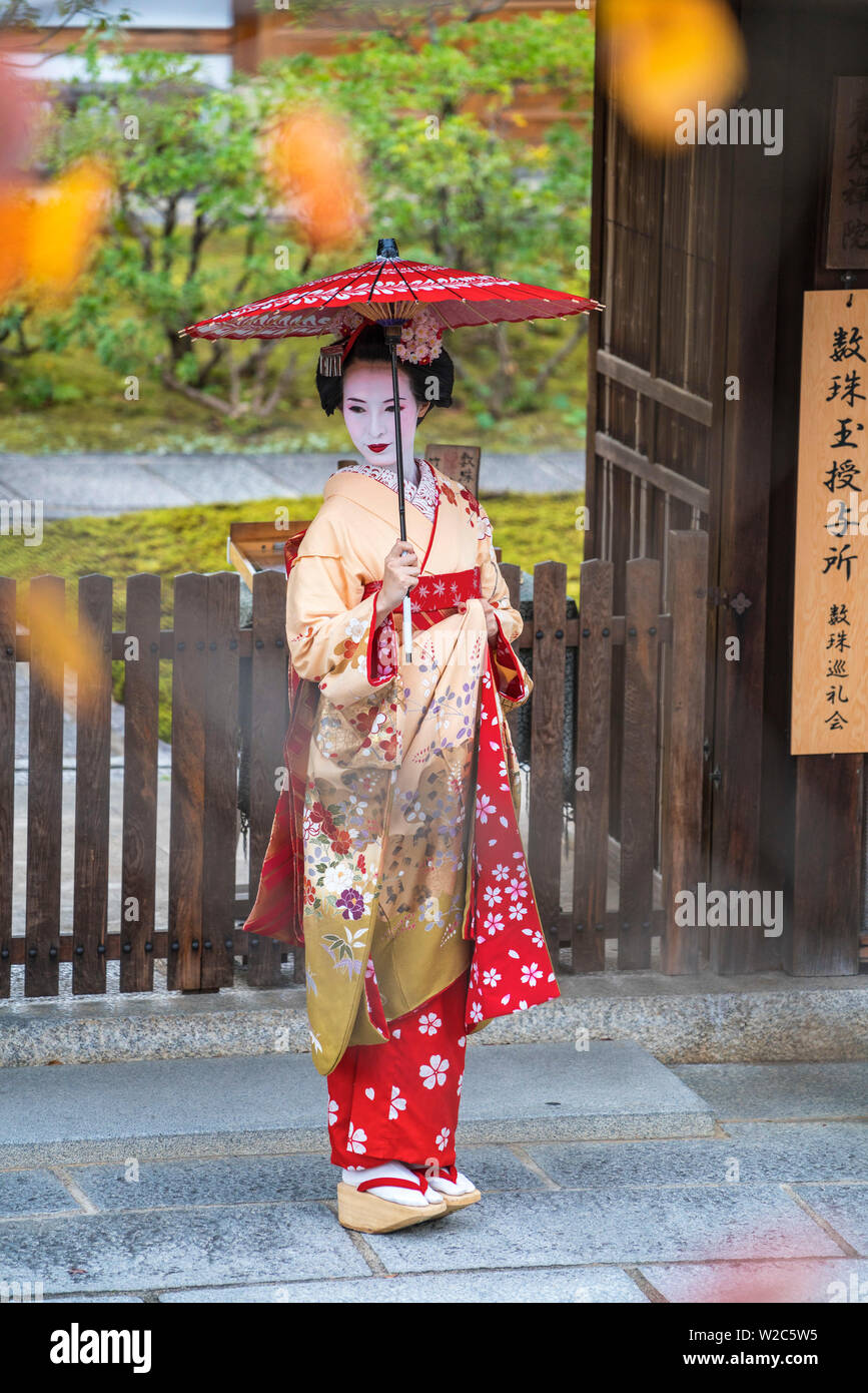 Woman in traditional dress with traditional umbrella, Arashiyama Sagano area, Kyoto, Japan Stock Photo