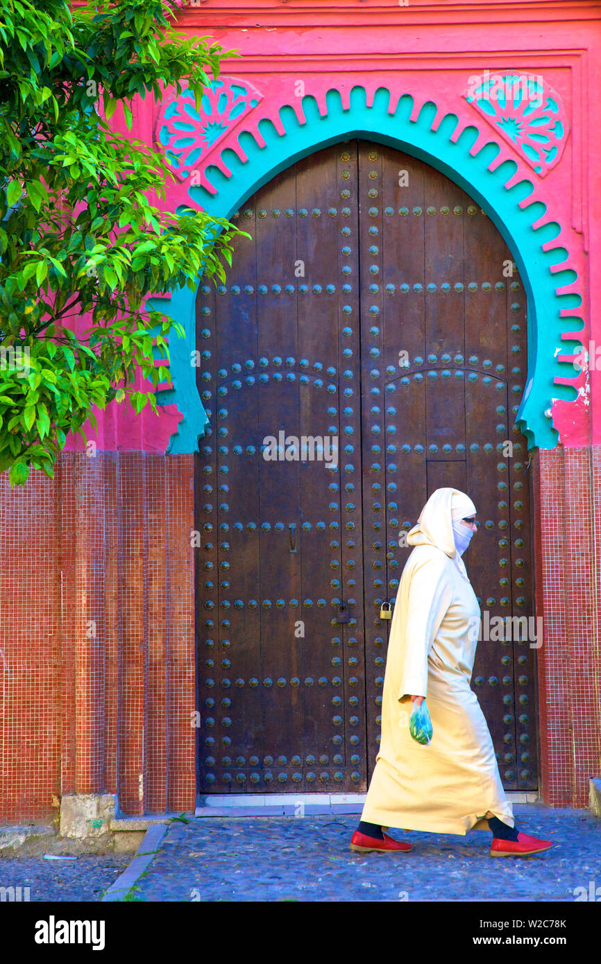 Person Walikng Infront Of Traditional Moroccan Decorative Door, Tangier, Morocco, North Africa Stock Photo