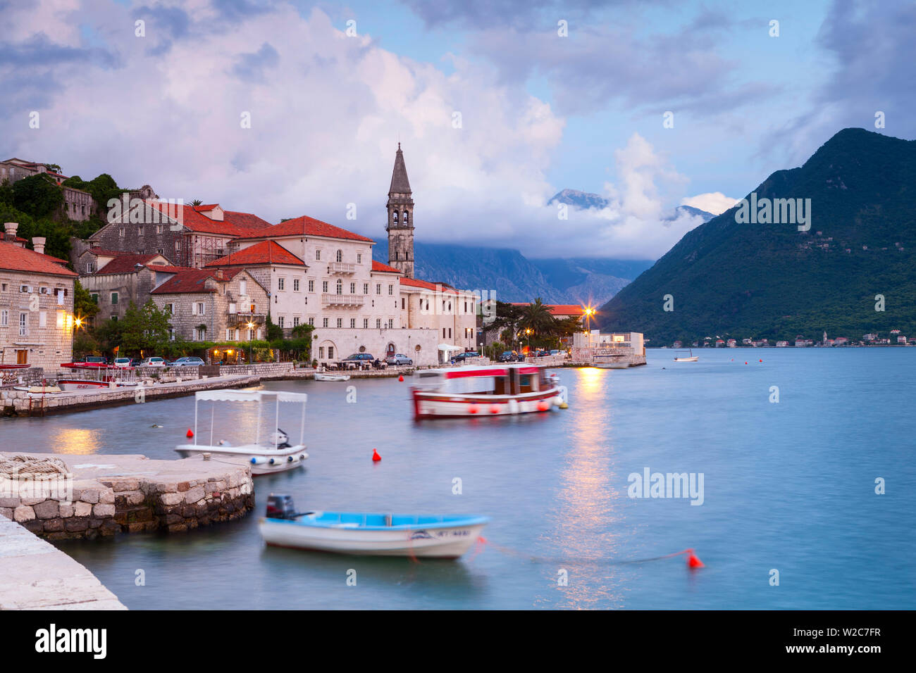 The picturesque coastal village of Perast illuminated at dusk, Perast, Bay of Kotorska, Montenegro Stock Photo