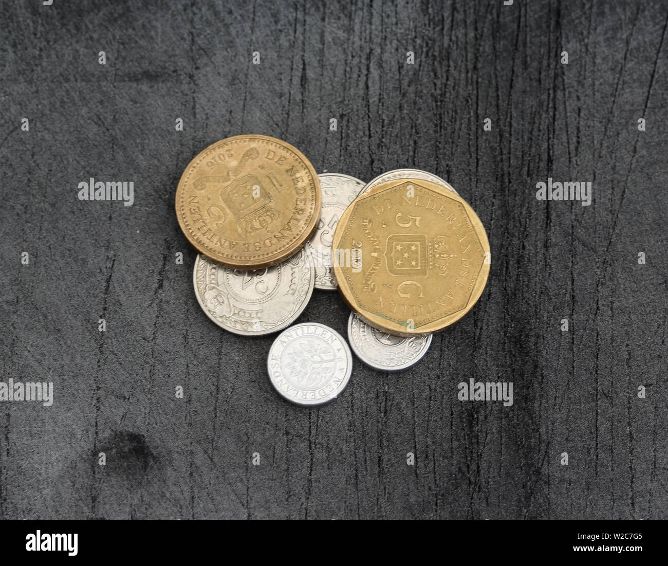 Close up of Stable of Netherlands Antillean guilder coins on black background Stock Photo