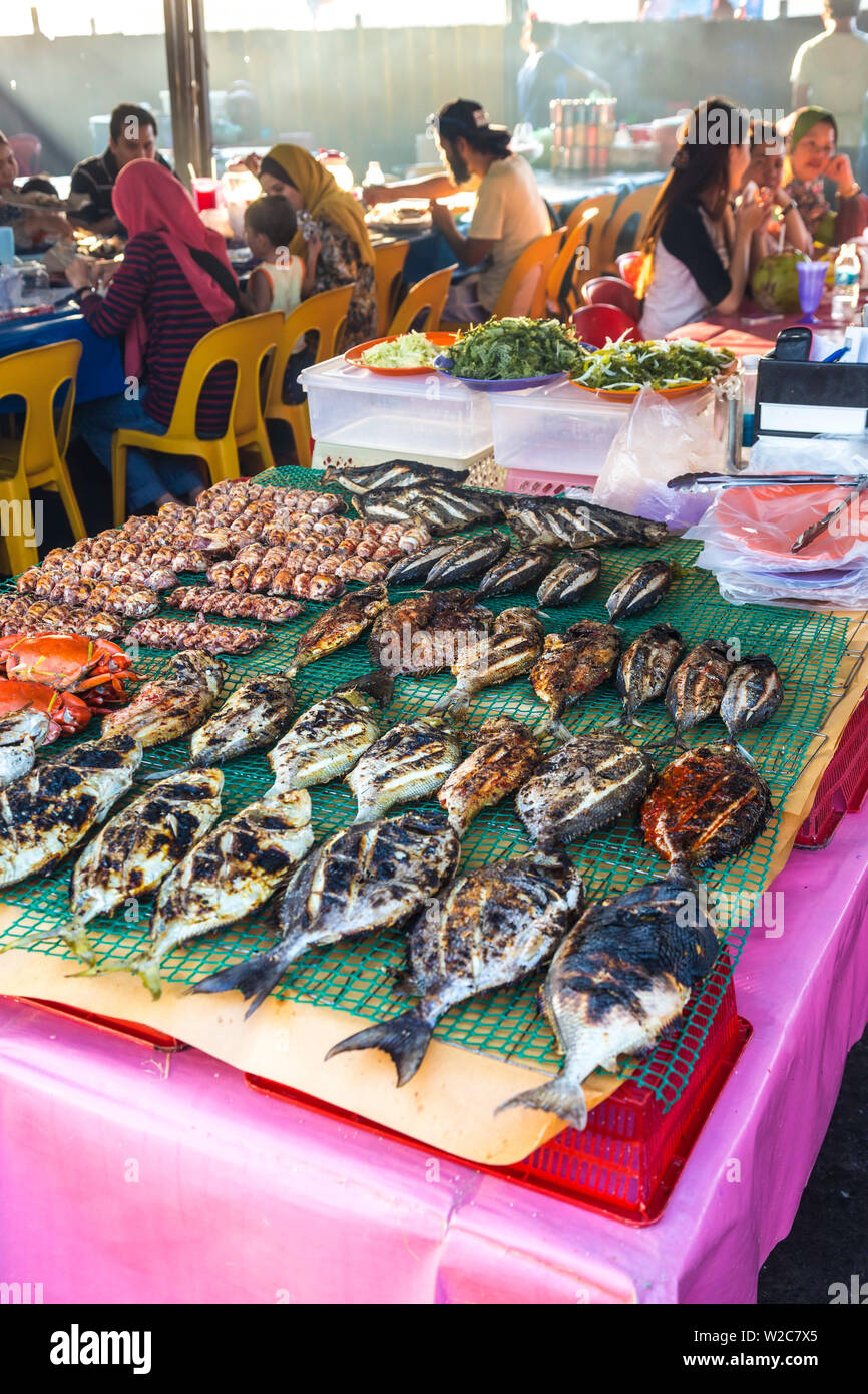 Barbecued fish at restaurant in Night food market, Kota Kinabalu, Sabah, Borneo, Malaysia Stock Photo