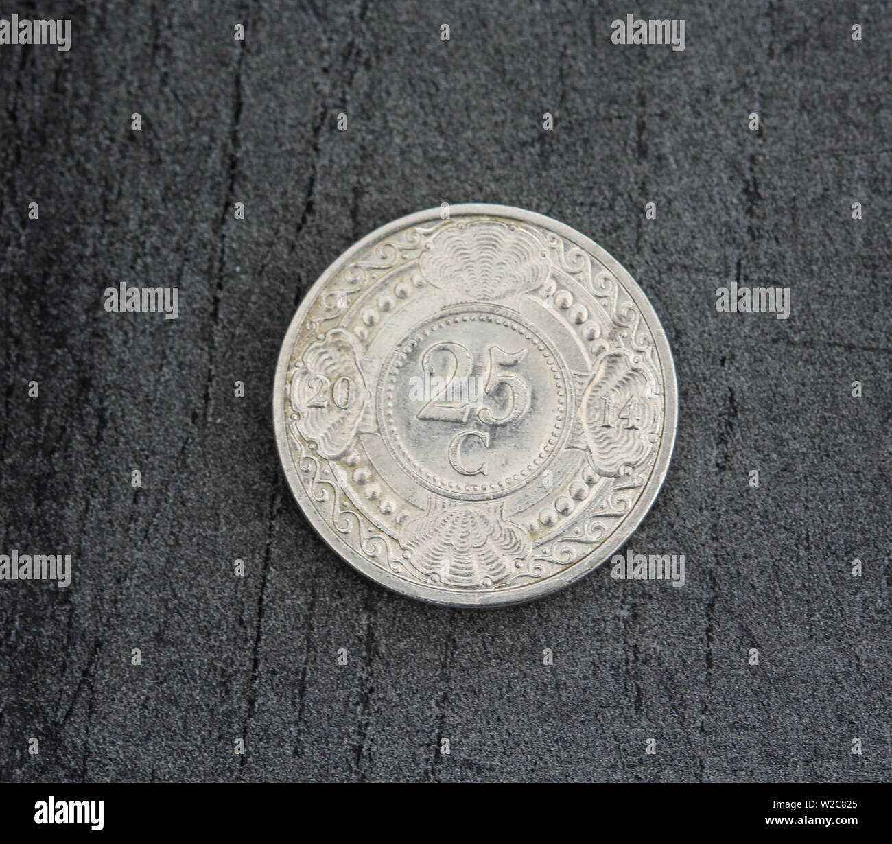 close up of 25 (twenty five) cent Netherlands Antillean guilder coin on black background Stock Photo