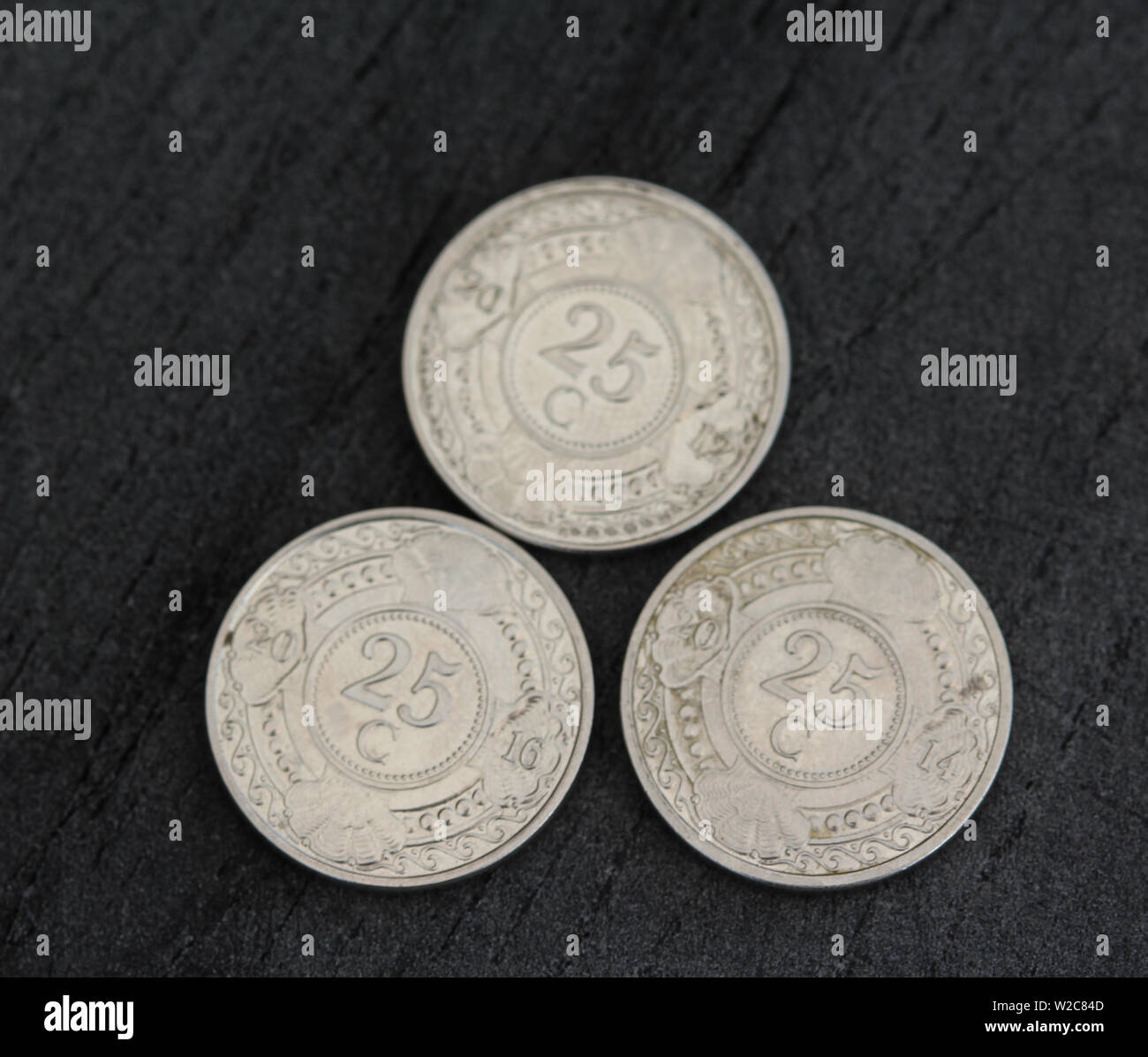 close up of 25 (twenty five) cent Netherlands Antillean guilder coin on black background Stock Photo