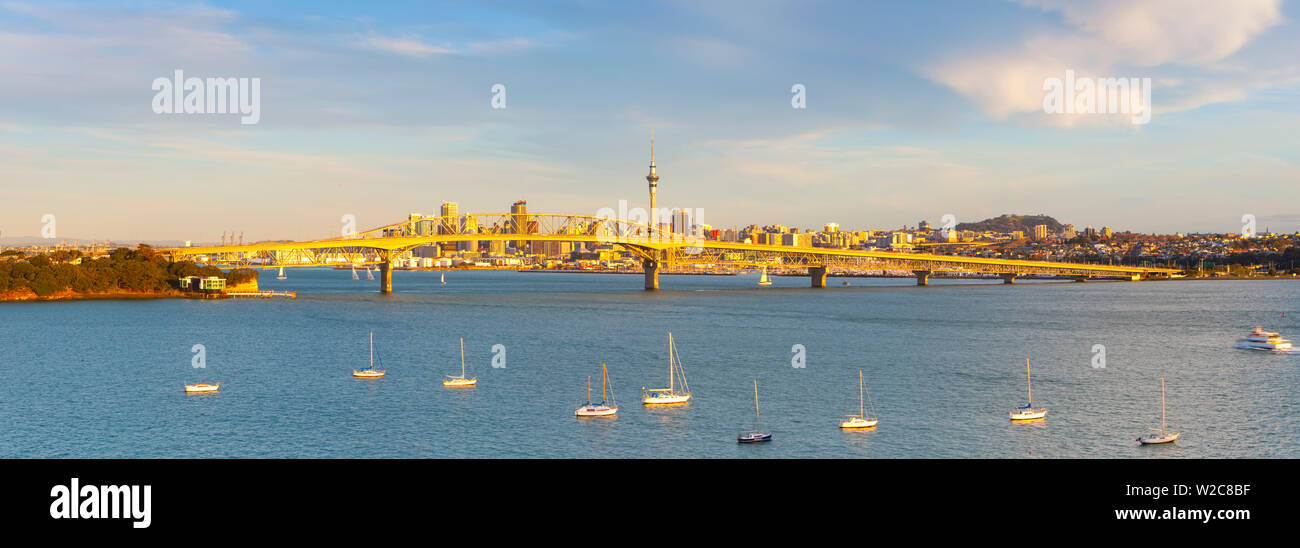 Elevated View Towards the Harbour Bridge and CBD illuminated at sunset, Auckland, North Island, New Zealand Stock Photo