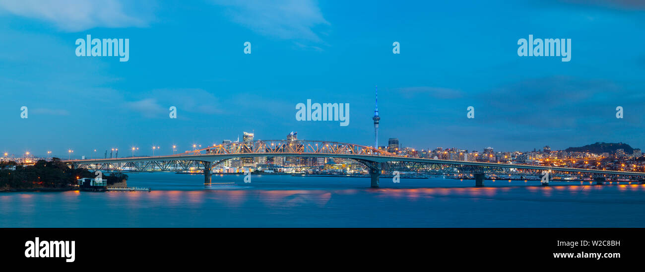 Elevated View Towards the Harbour Bridge and CBD illuminated at dusk, Auckland, North Island, New Zealand Stock Photo