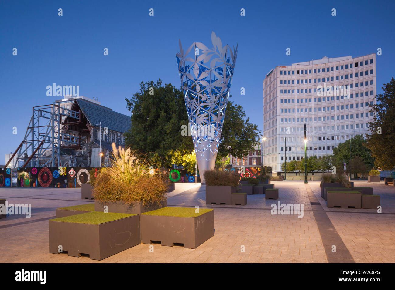 New Zealand, South Island, Christchurch, Cathedral Square, Chalice, sculpture by Neil Dawson, 2001 and building damaged in 2011 earthquake with ruins of Christchurch Cathedral, dusk Stock Photo