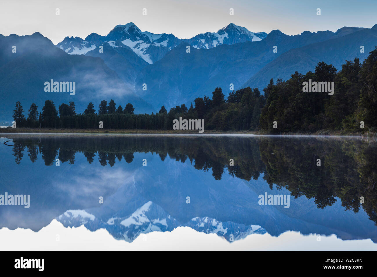 New Zealand, South Island, West Coast, Fox Glacier Village, Lake Matheson, reflection of Mt. Tasman and Mt. Cook, dawn Stock Photo