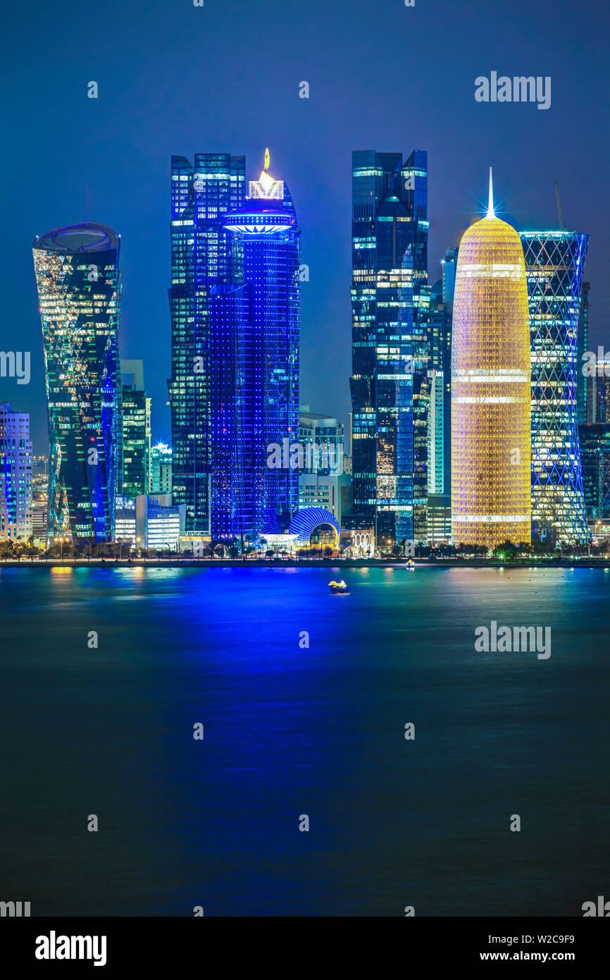 Qatar, Doha, new skyline of the West Bay central financial district of Doha, illuminated at dusk Stock Photo