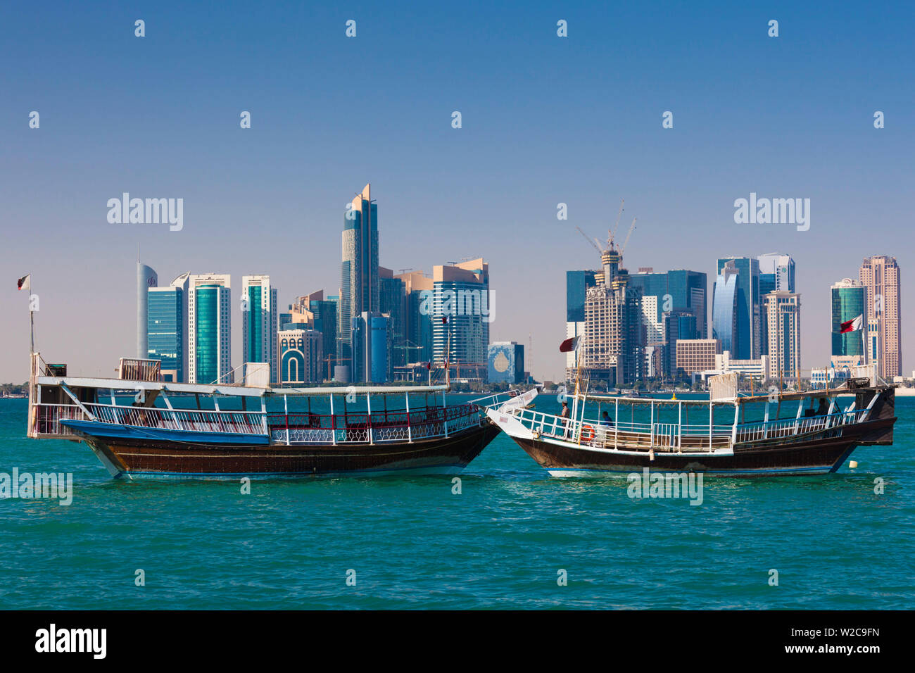 Qatar, Doha, Dhows on Doha Bay with West Bay skyscrapers Stock Photo