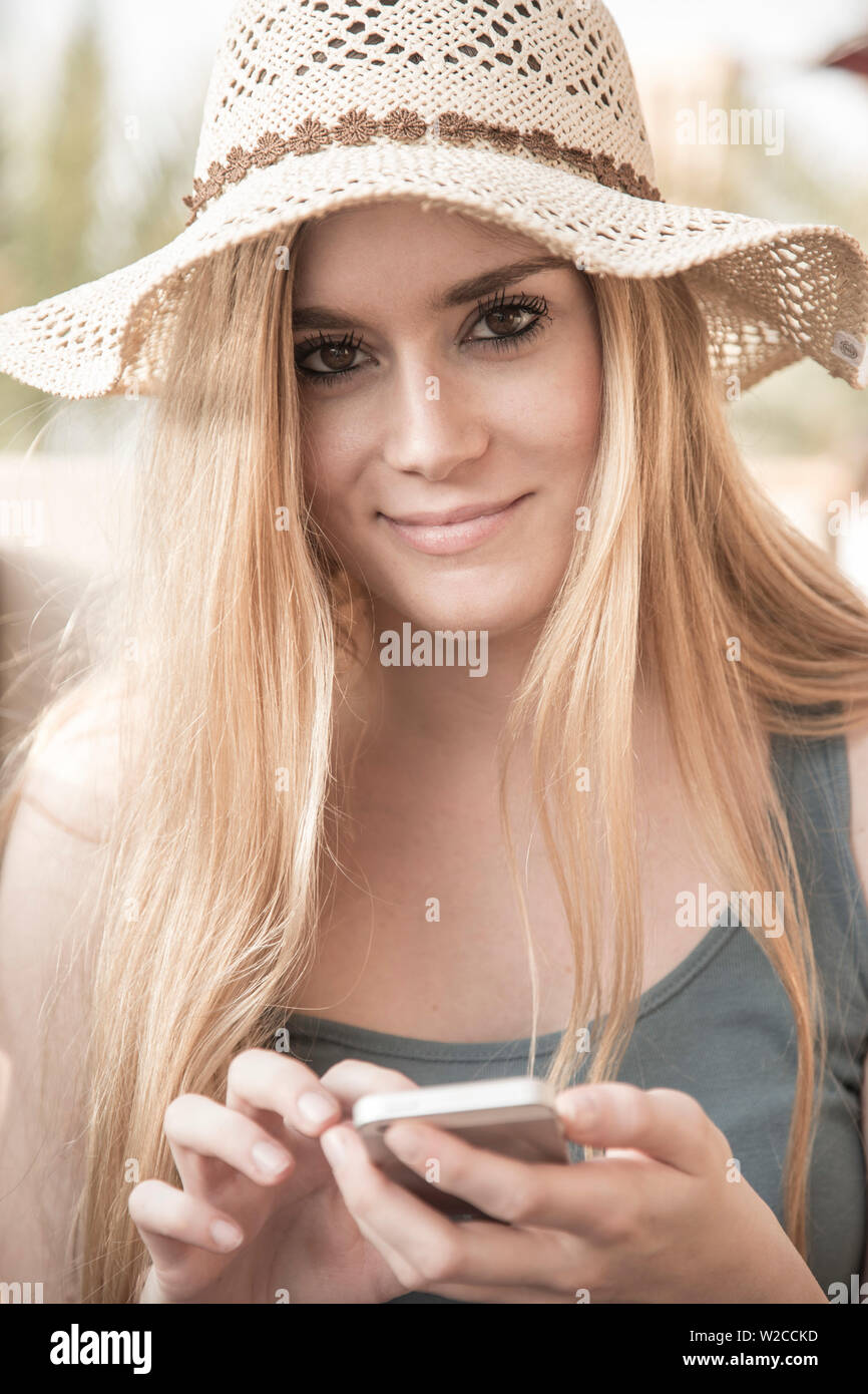 Woman using mobile phone, Dubai, United Arab Emirates (MR) Stock Photo