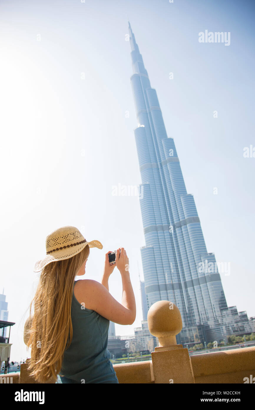 Woman photographing the Burj Khalifa in Downtown, Dubai, United Arab