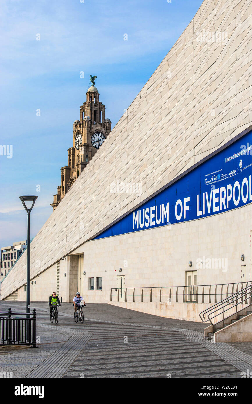 United Kingdom, England, Merseyside, Liverpool, Two men cycling past the Museum of Liverpool Stock Photo