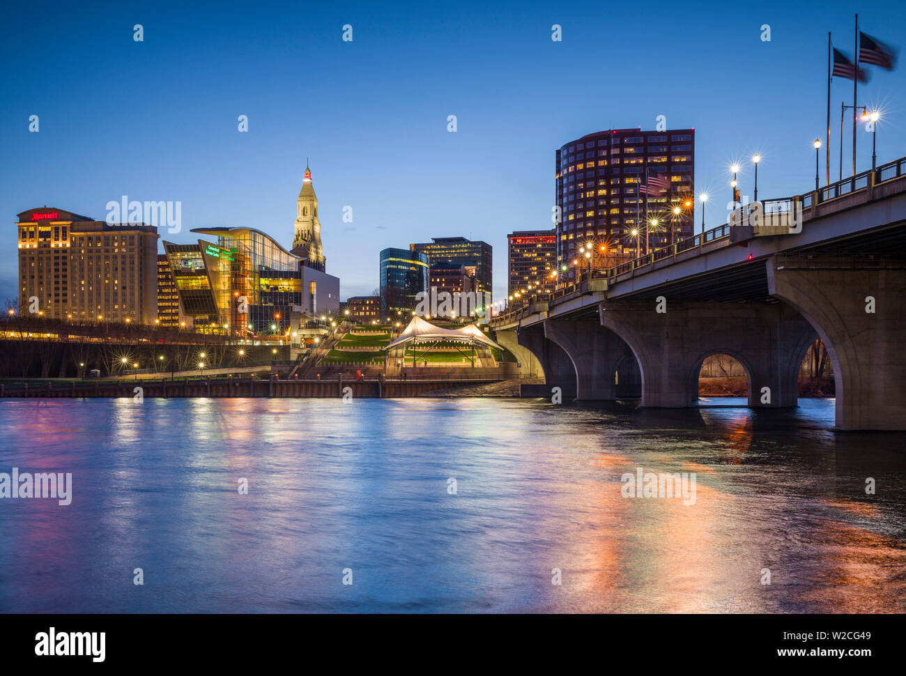 USA, Connecticut, Hartford, city skyline with Connecticut Science Center and Travelers Building, from the Connecticut River, dusk Stock Photo