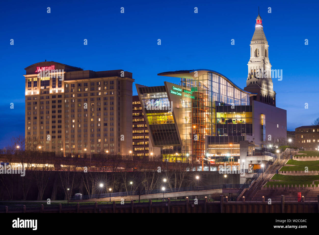 USA, Connecticut, Hartford, city skyline with Connecticut Science Center and Travelers Building, from the Connecticut River, dusk Stock Photo