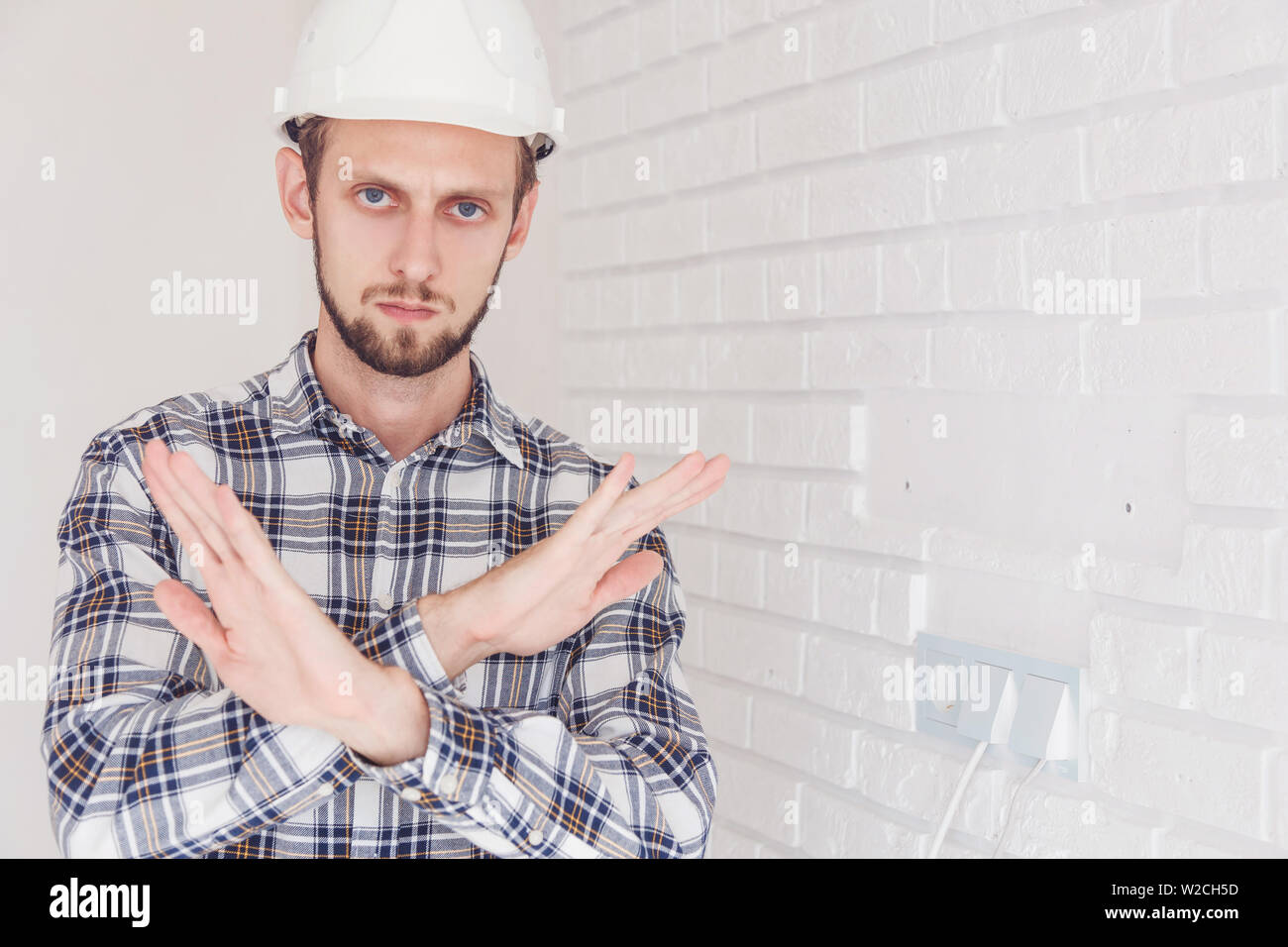 Foreman engineer, arms folded, shows a ban on action. Stock Photo