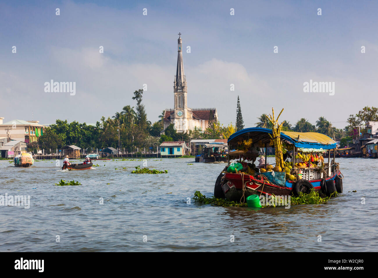 Vietnam, Mekong Delta, Cai Be, Cai Be Floating Market, with view of the Catholic Cathedral Stock Photo
