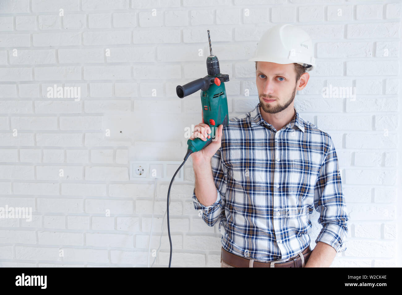 portrait of a constructor holding a drill Stock Photo