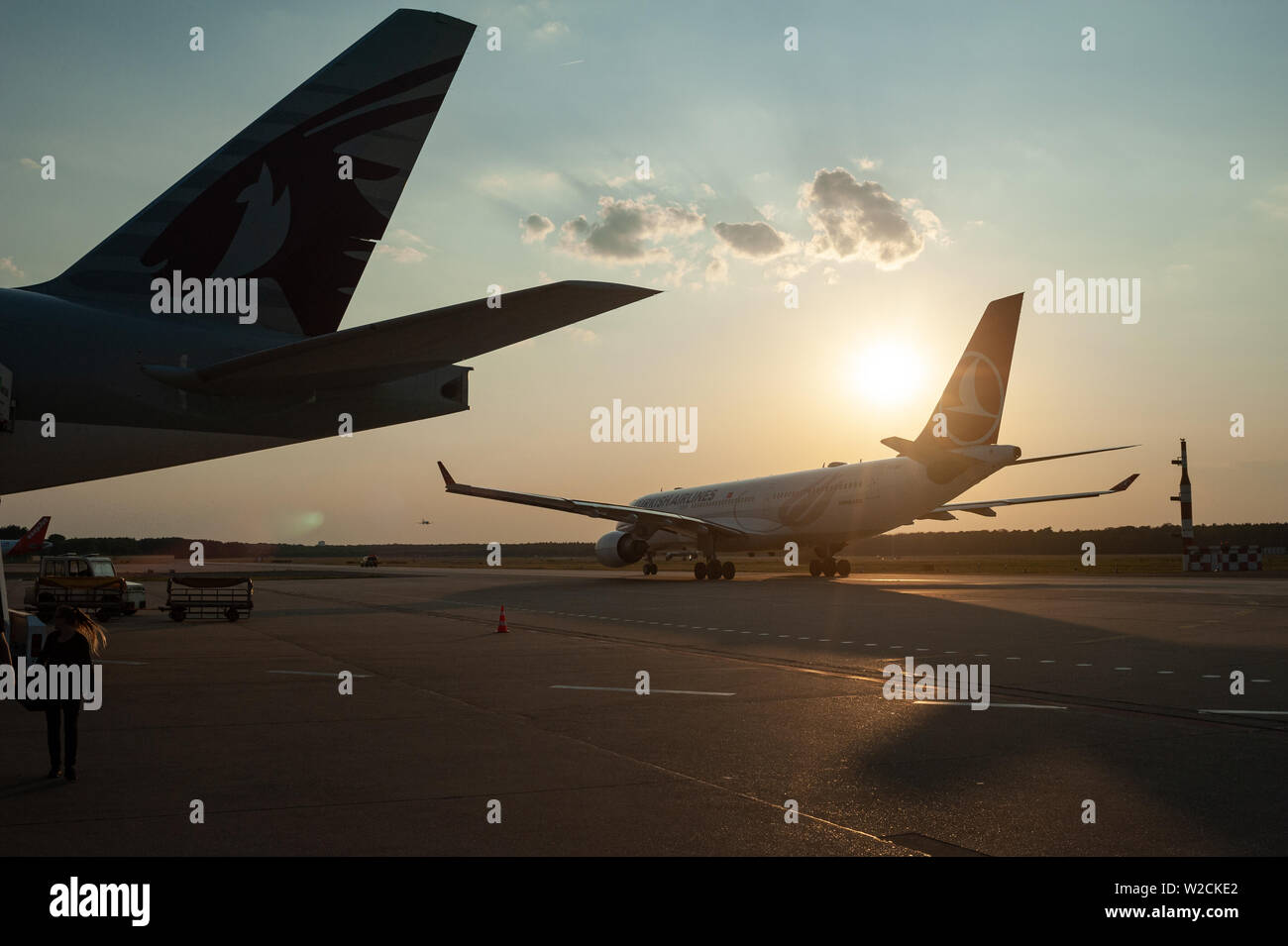 05.06.2019, Berlin, Germany, Europe - Passenger planes at Tegel Airport at dusk. Stock Photo