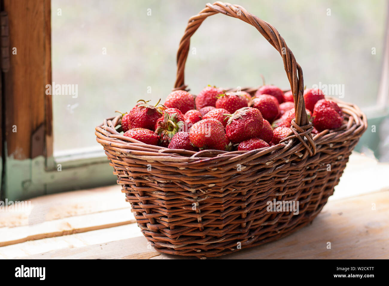 food basket with strawberries standing on balcony Stock Photo - Alamy