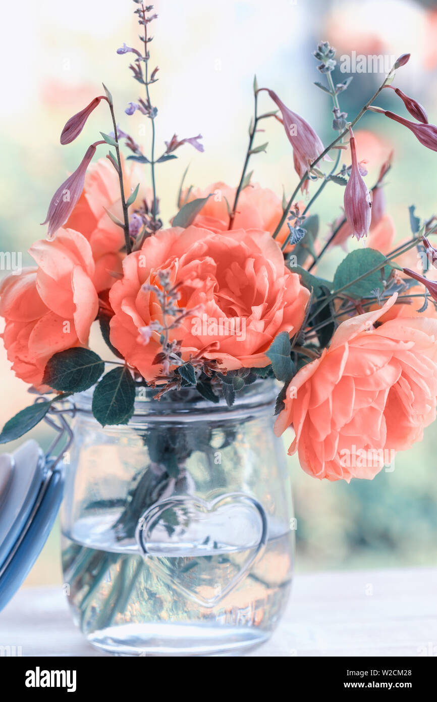 Glass Container With Roses Beautiful roses flowers. Bouquet of roses in a glass jar Stock Photo ...