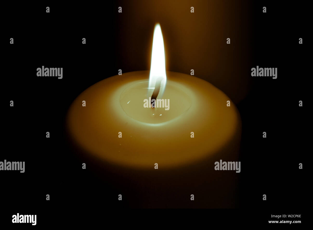 Candle flame in the dark background and space for text Stock Photo - Alamy