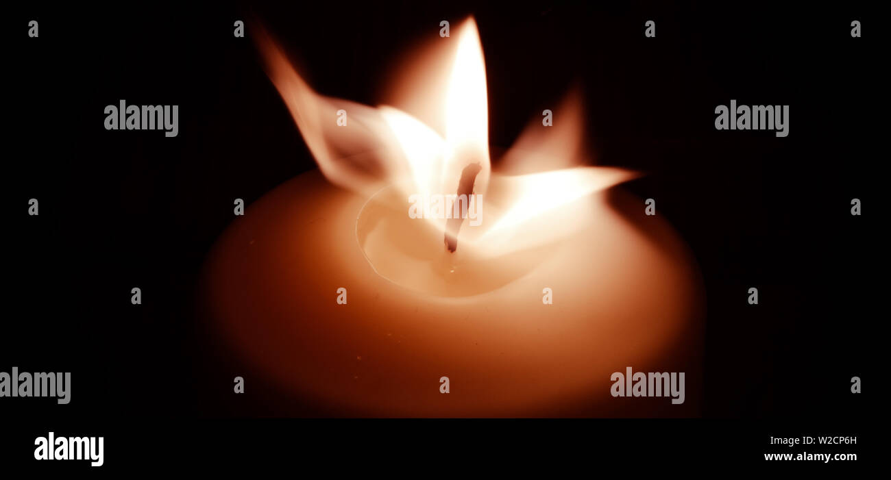 Candle flame in the dark background and space for text Stock Photo - Alamy