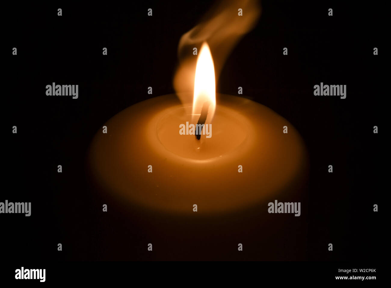 Candle flame in the dark background and space for text Stock Photo - Alamy