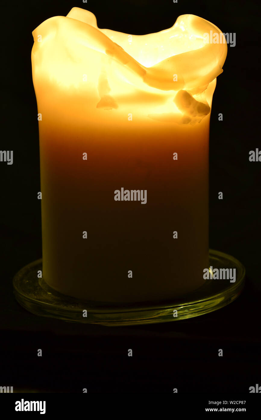 Burning candle on a black background flame photography Stock Photo