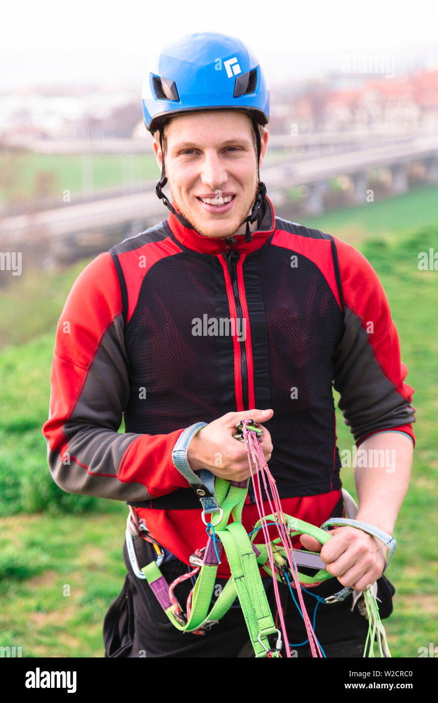 Young parachutist holding parachute slings and smiles Stock Photo Alamy